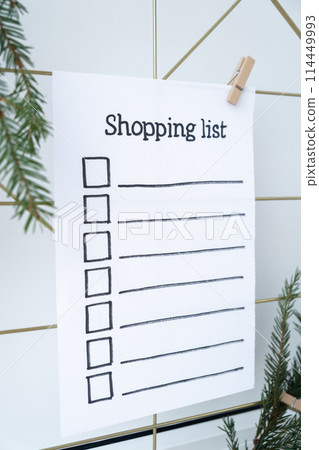 Preparation for winter holidays. SHOPPING LIST text on paper note. Celebration gifts and presents preparing Natural zero waste homemade Christmas decor. Happy new year 114449993