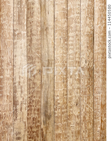 Vertical background image of a rough-hewn light brown surface wooden wall 114450580
