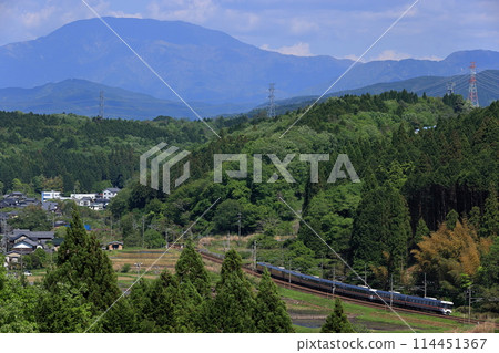 The Shinano Express train runs along the Chuo Line with Mount Ena in the background, and fresh greenery. The Shinano Express train runs along the Chuo Line with Mount Ena in the background, and fresh greenery. 114451367