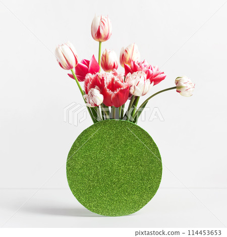Hello spring. Pink and white tulips in a vase on a table with a place for text. Happy Mother's Day greeting card, happy Valentine's Day, March 8, happy birthday Hello spring. Pink and white tulips in a vase on a table with a place for text. Happy Mother's Day greeting card, happy Valentine's Day, March 8, happy birthday 114453653