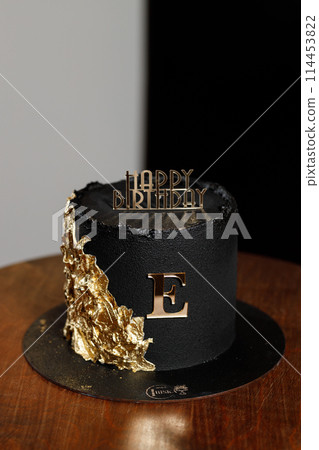 Black velor cake with gold letters and decoration Black velor cake with gold letters and decoration 114453822
