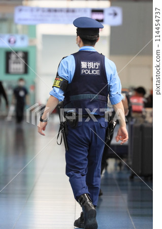 Police officers patrolling the airport Back view Security Metropolitan Police Department Police officers patrolling the airport Back view Security Metropolitan Police Department 114454737