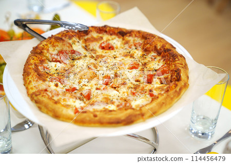 close-up. A large margherita pizza on the table with appetizers for the holiday. 114456479