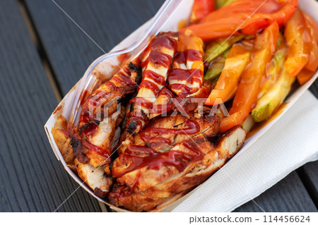 Fast food container with chicken, vegetables, and fork for convenience Fast food container with chicken, vegetables, and fork for convenience 114456624