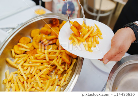 Heated tray with french fries and nuggets. Banquet food delivery. 114456630
