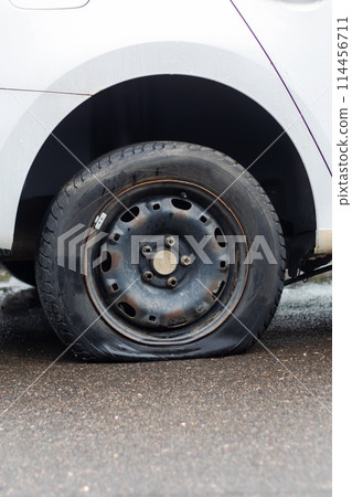 A flat tire on road side, car wheel stuck, needs repair 114456711