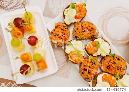 Assorted canapes for the festive table. Catering services for banquets.  114456774
