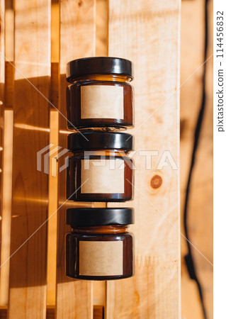 Scented candles on a wooden table.  114456832