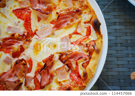 Close-up of cheese with bacon pizza.  114457066