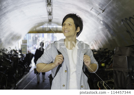 A young foreign man strolling through the streets of Shibuya 114457344