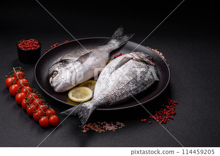 Whole raw dorado fish with lemon, salt, spices and herbs Whole raw dorado fish with lemon, salt, spices and herbs 114459205