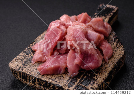 Slices of raw pork or turkey meat with salt, spices and herbs Slices of raw pork or turkey meat with salt, spices and herbs 114459212