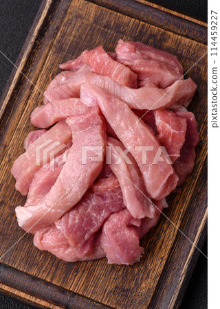 Slices of raw pork or turkey meat with salt, spices and herbs Slices of raw pork or turkey meat with salt, spices and herbs 114459227
