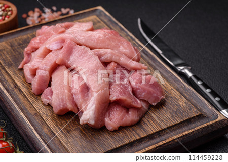 Slices of raw pork or turkey meat with salt, spices and herbs Slices of raw pork or turkey meat with salt, spices and herbs 114459228