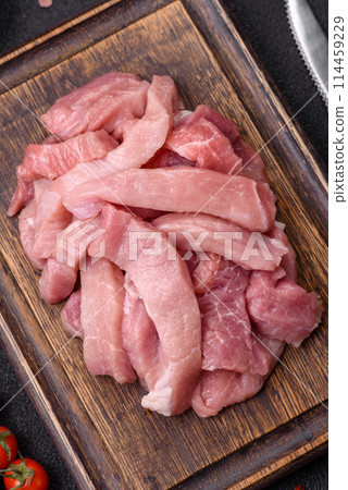 Slices of raw pork or turkey meat with salt, spices and herbs Slices of raw pork or turkey meat with salt, spices and herbs 114459229