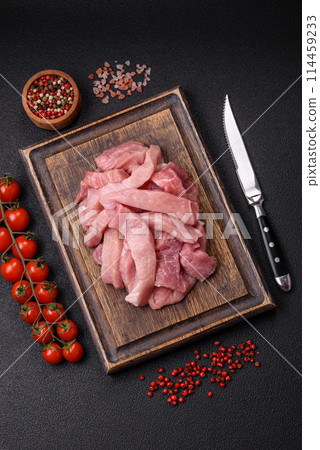 Slices of raw pork or turkey meat with salt, spices and herbs Slices of raw pork or turkey meat with salt, spices and herbs 114459233