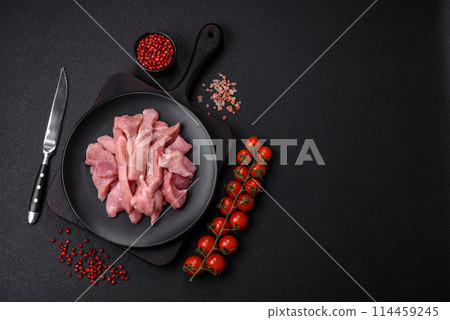 Slices of raw pork or turkey meat with salt, spices and herbs Slices of raw pork or turkey meat with salt, spices and herbs 114459245