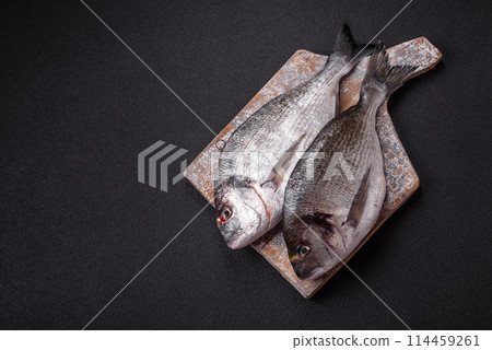 Whole raw dorado fish with lemon, salt, spices and herbs Whole raw dorado fish with lemon, salt, spices and herbs 114459261