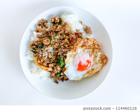 Rice topped with pork with Thai basil and fried egg 114460128