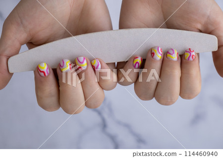 Manicure tools Woman manicured hands, stylish summer colorful nails. Closeup of manicured nails of female hand. Summer style of nail design concept. Beauty Manicure tools Woman manicured hands, stylish summer colorful nails. Closeup of manicured nails of female hand. Summer style of nail design concept. Beauty 114460940