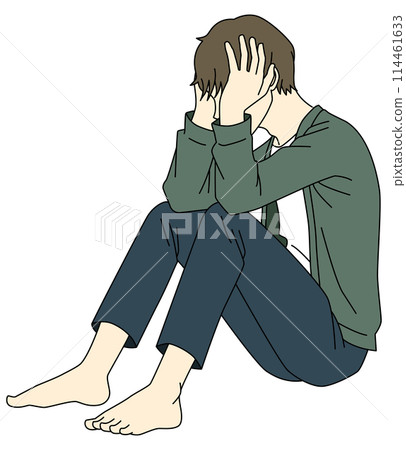 A man sitting on the floor with his head in his hands and worried 114461633