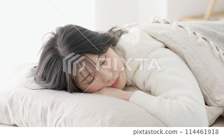 Asian woman sleeping on stomach Asian woman sleeping on stomach 114461918