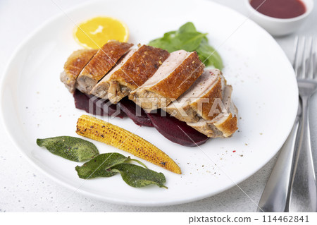 Files of the breast duck grill with beets, mini corn and spinach, fried sage, orange and lingonberry sauce. Traditional Mediterranean cuisine. Selective focus, close-up. 114462841