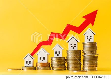 Coins on a table, a red up arrow and house. The concept of the rising price of real estate 114462930
