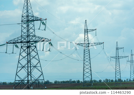 High voltage towers with sky background. Power line support with wires for electricity transmission. High voltage grid tower with wire cable at distribution station. Energy industry, energy saving 114463290