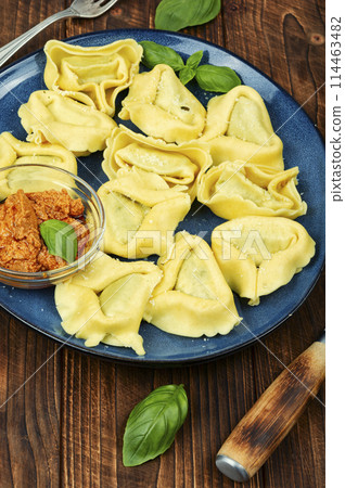 Tortelloni, Italian dumplings on wooden table Tortelloni, Italian dumplings on wooden table 114463482