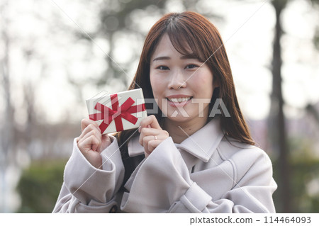 A woman with a present A woman with a present 114464093