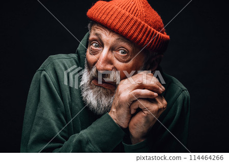 Frightened bearded homeless tramp man coweres, defending himself from a blow Frightened bearded homeless tramp man coweres, defending himself from a blow 114464266