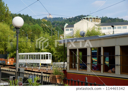 TURIN, ITALY - SEP 14, 2019: The old, still functioning rack railway Sassi Superga leads from the Sassi district of Turin up the Superga mountain to the Basilica di Superga pilgrimage church TURIN, ITALY - SEP 14, 2019: The old, still functioning rack railway Sassi Superga leads from the Sassi district of Turin up the Superga mountain to the Basilica di Superga pilgrimage church 114465342