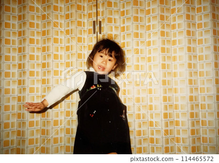 1970s: A girl posing in front of an accordion curtain 1970s: A girl posing in front of an accordion curtain 114465572
