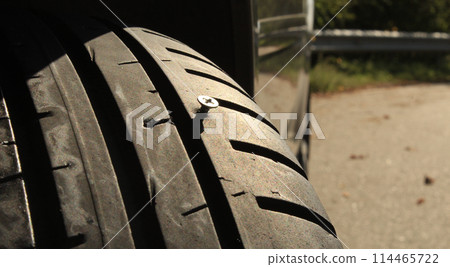 Screw Sticks Out Of Vehicle Tire Screw Sticks Out Of Vehicle Tire 114465722