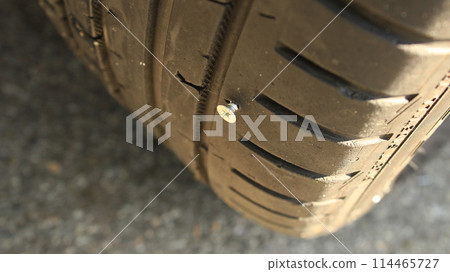 Vehicle Tire Punctured By The Screw Vehicle Tire Punctured By The Screw 114465727