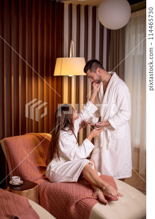 young awesome girl thanking her boyfriend for coffee in the morning indoors 114465730