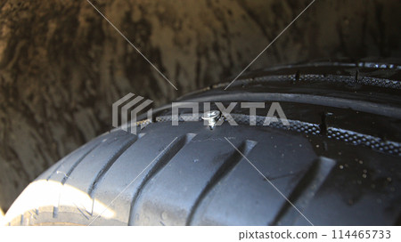 Metal Screw In Run Flat Tire Closeup Metal Screw In Run Flat Tire Closeup 114465733