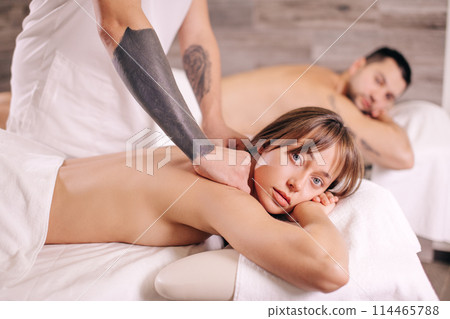 serious blond woman looking at the camera while getting massage serious blond woman looking at the camera while getting massage 114465788