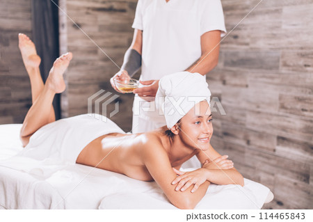young positive girl is going to have aroma therapy massage young positive girl is going to have aroma therapy massage 114465843