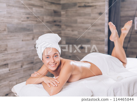 positive female holidaymaker relaxing after shower positive female holidaymaker relaxing after shower 114465844