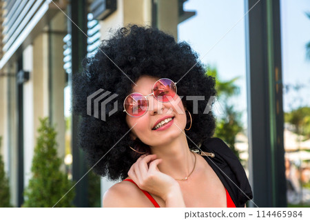 Portrait of a multiethnic woman with black hair wearing red clothes 114465984