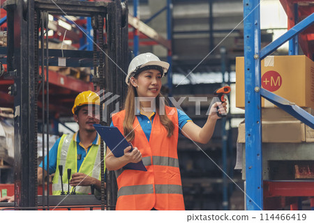 Warehouse management team use bar code scaner scan goods shelf writing checklist on clipboard. Asian men women worker check stock inventory. Teamwork logistics staff counting products store inventory 114466419