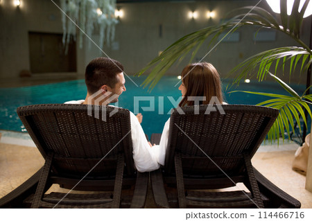 two young people spending their time by the swimming pool 114466716