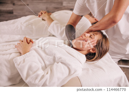 a couple spending time in the spa salon a couple spending time in the spa salon 114466770