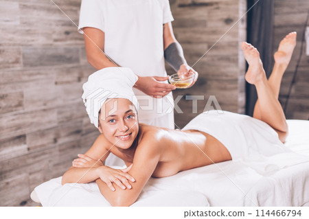 positive girl is waiting the massage with oils 114466794