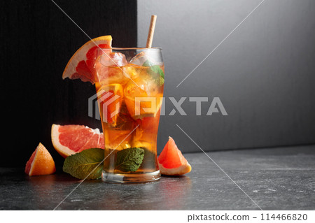 Iced tea or a summer refreshing drink with ice, mint, and grapefruit. 114466820