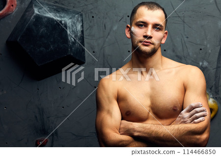 Portrait of cheerful rock climber in indoor climbing gym Portrait of cheerful rock climber in indoor climbing gym 114466850