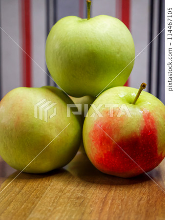 Organic Apples on Wood. A group of apples on a wooden backdrop, perfect for organic food marketing. Organic Apples on Wood. A group of apples on a wooden backdrop, perfect for organic food marketing. 114467105