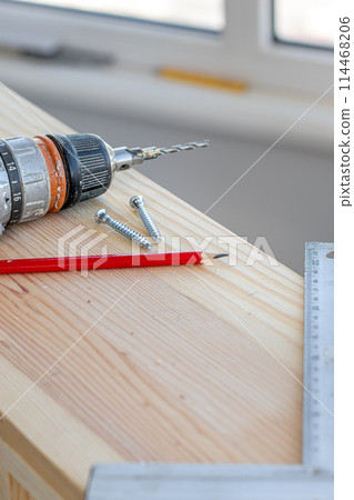 a screwdriver, a square, two confirmations and a pencil on the board a screwdriver, a square, two confirmations and a pencil on the board 114468206